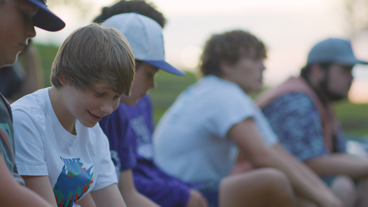 Shy kid smiles during a Club talk