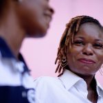 adult walking and talking to teen