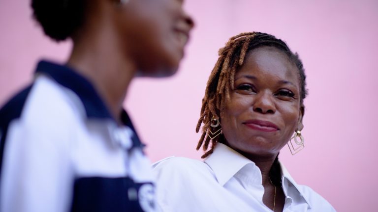 adult walking and talking to teen