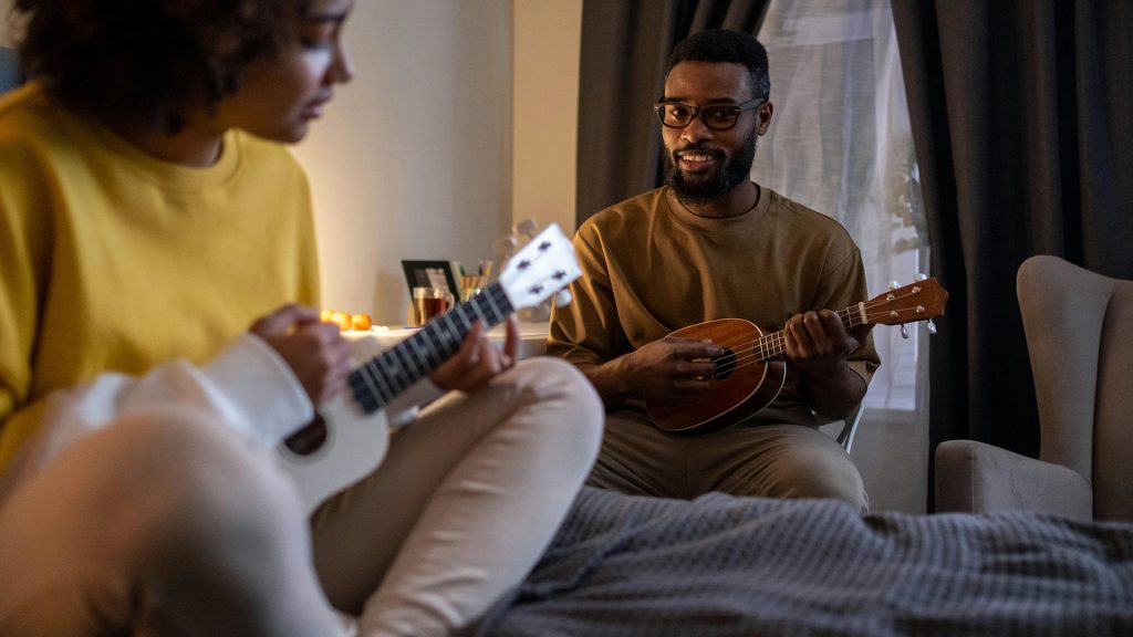 father playing guitar with daughter