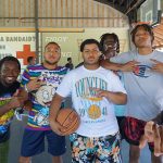 kids on a basketball court with medical signage in background