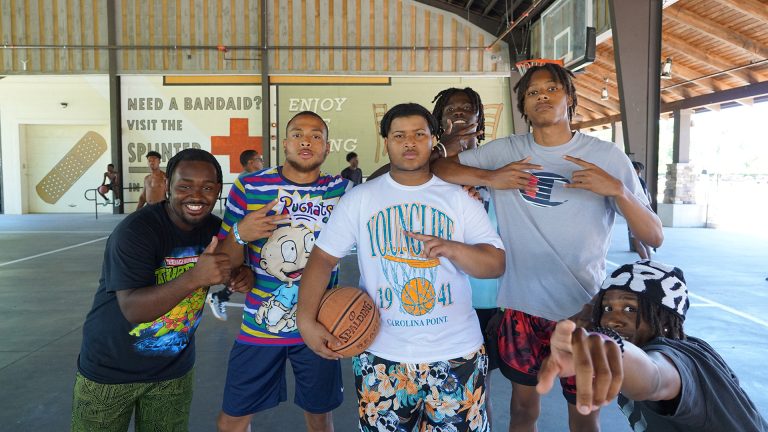kids on a basketball court with medical signage in background