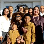 Generations posing together on a porch