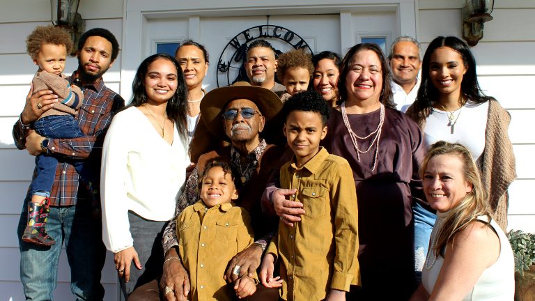 Generations posing together on a porch