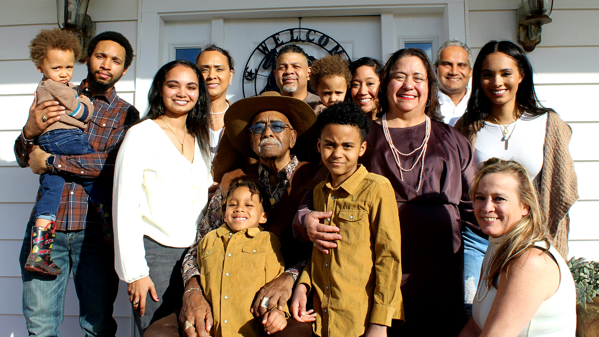 Generations posing together on a porch